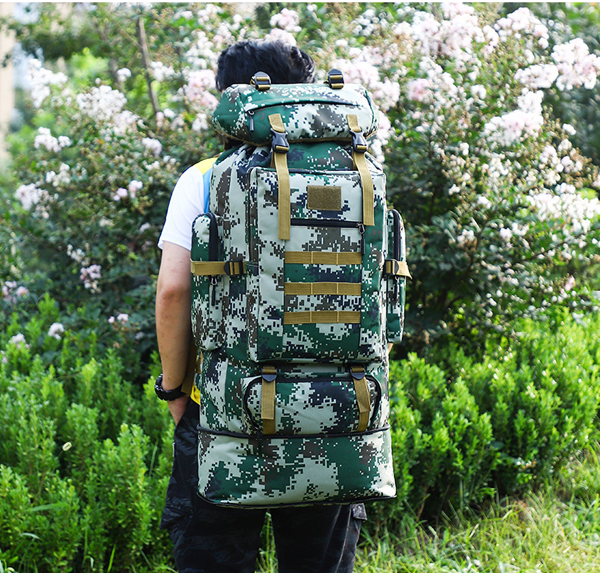 Black ECOTREK 100L hiking and camping backpack with large capacity, adjustable straps, multiple compartments, ideal for outdoor travel.