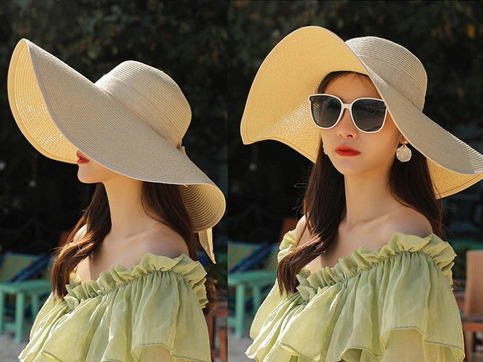 Beige women's straw sun hat with wide brim, floppy derby style, perfect for summer beach outings and outdoor protection