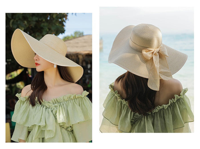 Beige women's wide-brim straw sun hat with large floppy brim, perfect for summer beach and outdoor wear.