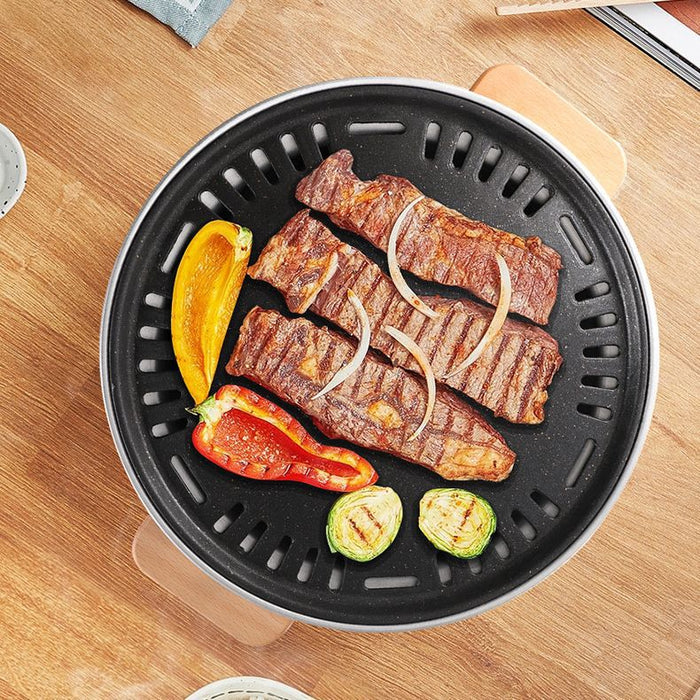Portable charcoal barbecue grill from dealonline.co.nz, compact outdoor stove with cooking grate and lid for home or party use