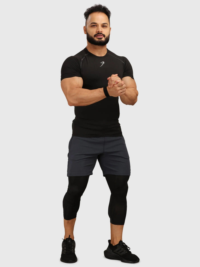Black Fuaark Nz compression T-shirt for men, close-up view showing fitted design and smooth fabric.