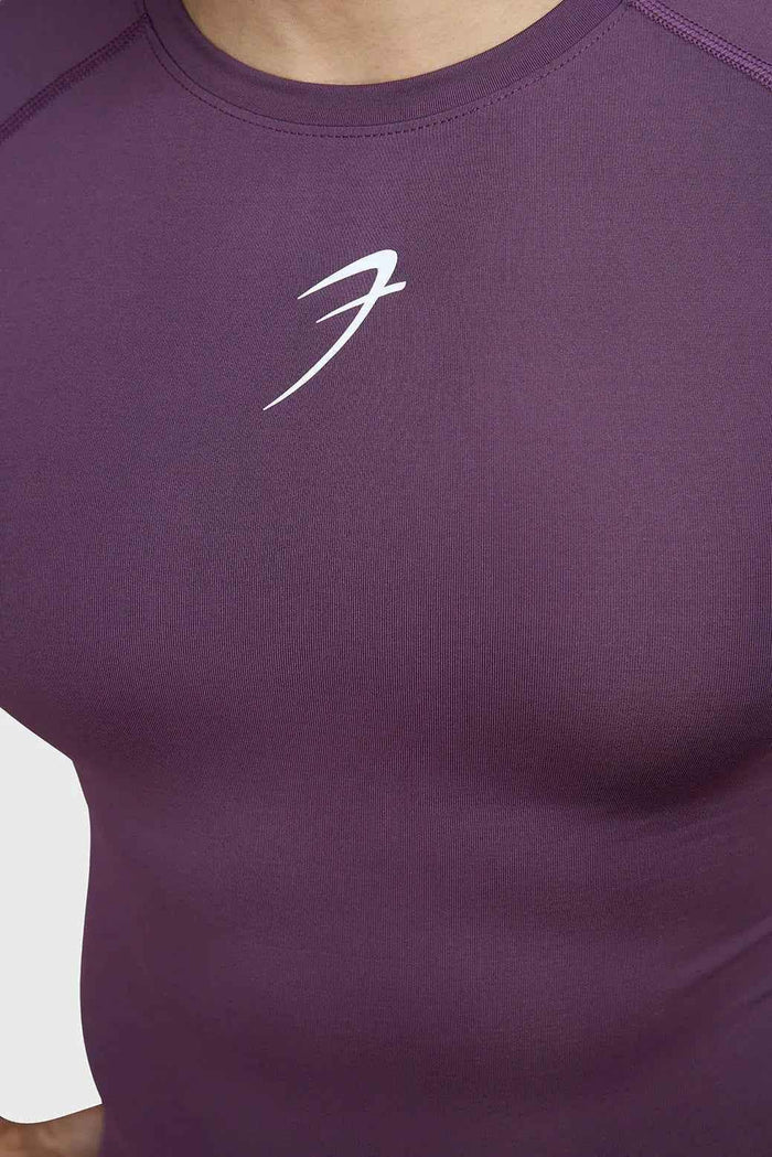 Fuaark Nz compression T-shirt in plum color, featuring a snug fit and breathable fabric for athletic performance.