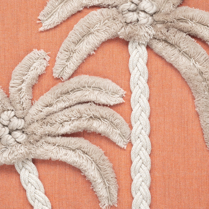 Embroidered palm tree design on a peach fabric background