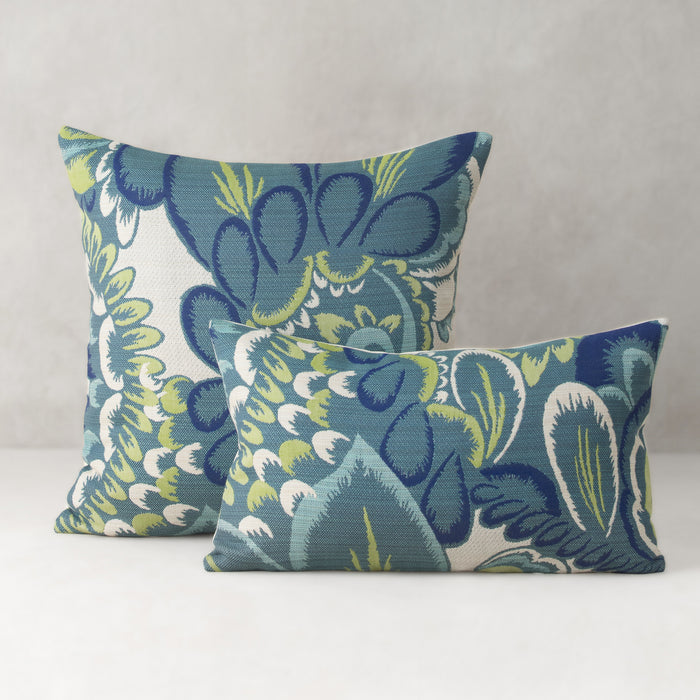 Two decorative pillows with a floral pattern on a neutral background
