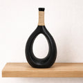 Black ceramic teardrop sculptural vase with smooth curves, designed by Nest & Stem Homewares for modern home decor.