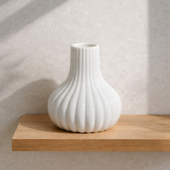 White fluted ceramic bud vase from Nest & Stem Homewares, designed for small floral arrangements and decorative display.