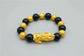 Stylish 3Sixty5 gold bracelet with black beads, featuring a sleek and elegant design for versatile jewelry wear.
