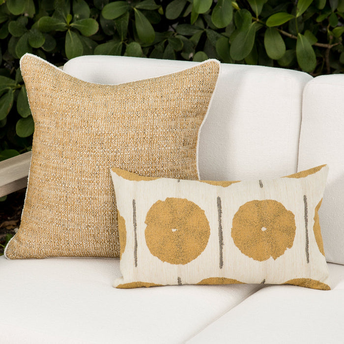 Luxury gold geometric patterned accent pillow on an indoor and outdoor sofa, featuring solution dyed performance fibers for hospitality and commercial spaces