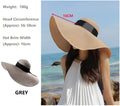 Grey women's straw sun hat with a wide brim, floppy derby style, perfect for summer beach or outdoor wear.