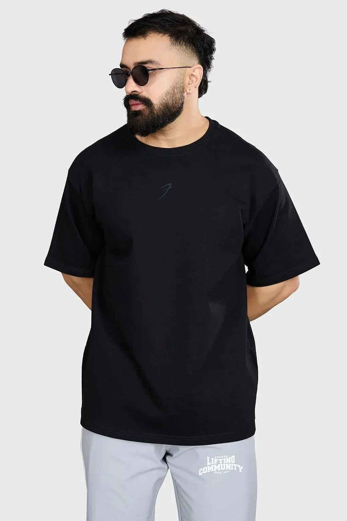 Black heavyweight oversized T-shirt by Fuaark Nz, showcasing a comfortable and stylish fit with a relaxed, casual design.