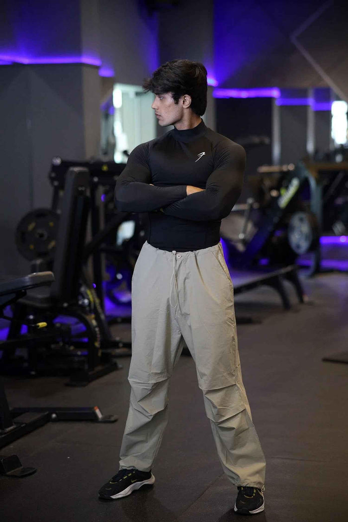 Black high neck compression T-shirt by Fuaark Nz with full sleeves, designed for performance and athletic wear.