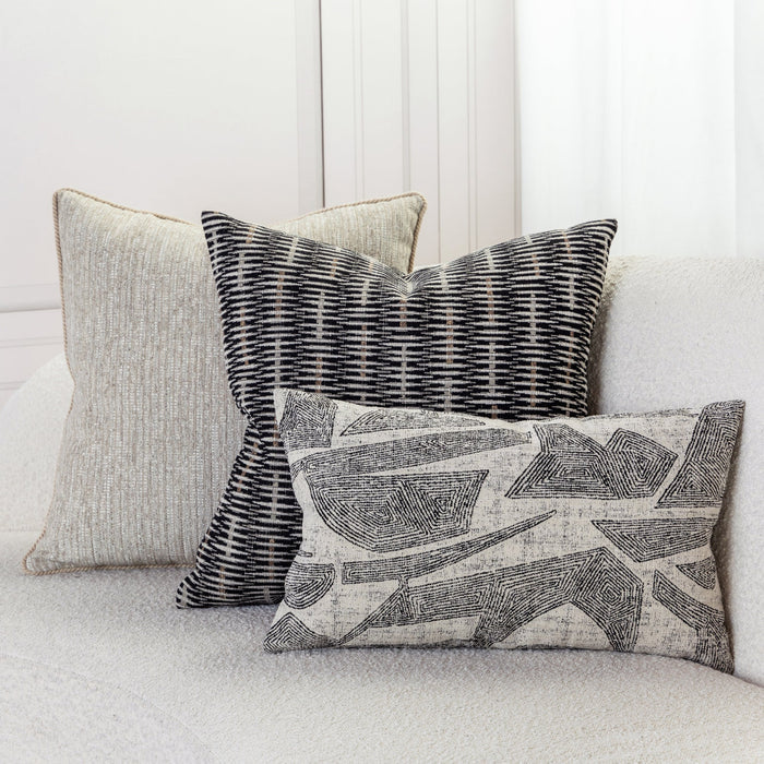Two woven textured accent pillow in black and beige on ivory sofa by elaine smith