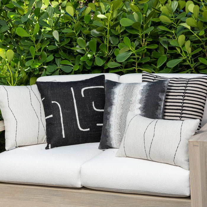 Luxury black and white geometric patterned square pillow on a outdoor sofa, featuring commercial grade construction for luxury hotel and resort design