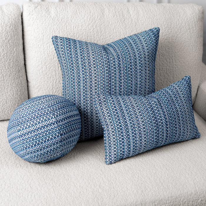 Blue patterned cushions on a light gray sofa