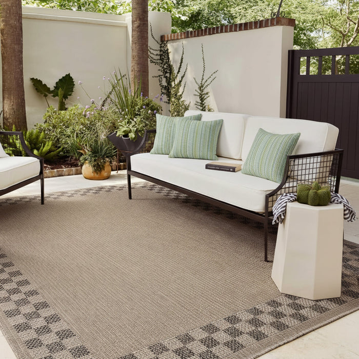 fresh spring striped pillows on ivory outdoor sofa