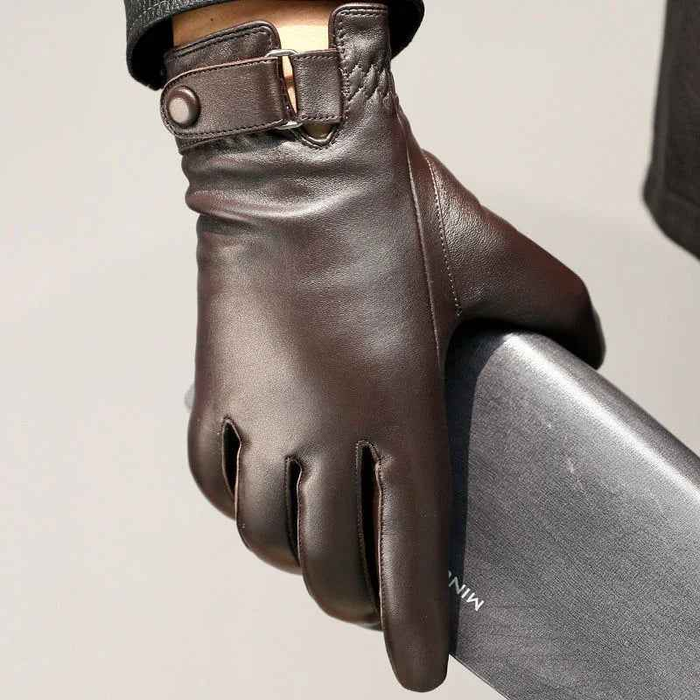 Black leather gloves with velvet lining from Mead's Supply & Equipment Outfitters, showing close-up of the textured leather and soft interior.