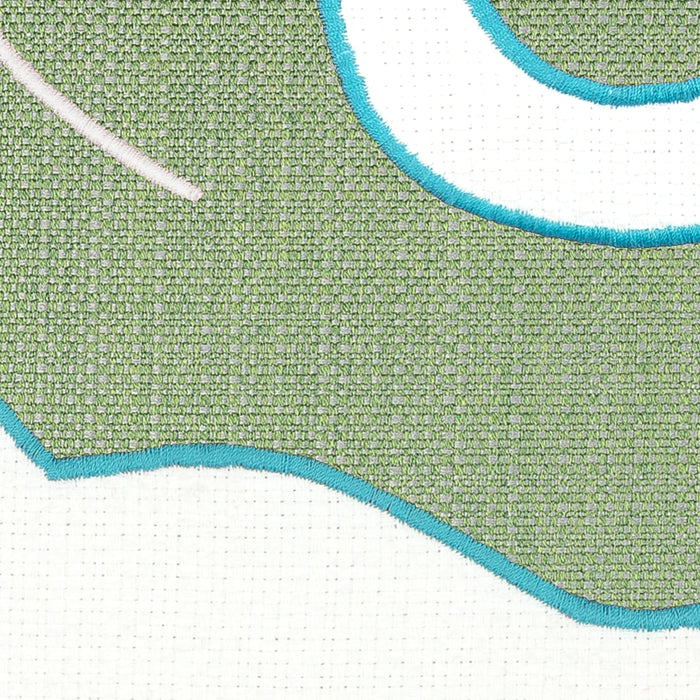 Detail image of Green and white western inspired design on outdoor pillow with aruba tassels for vibrant patio decor