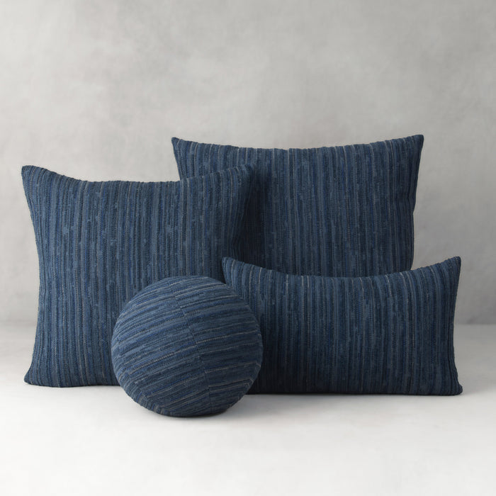 Set of blue textured cushions on a light gray background