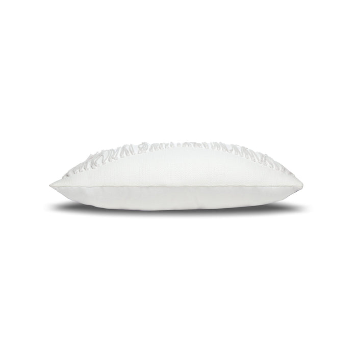 Side image of White textured outdoor pillow with fringe details and tassels on top corners for modern indoor and outdoor decor by Elaine Smith