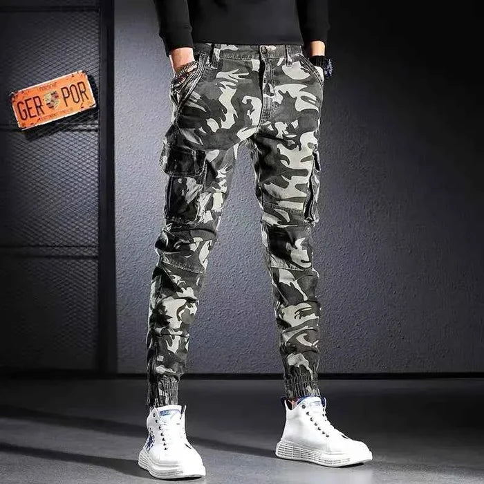 Men's oversized camouflage cargo pants by Mead's Supply & Equipment Outfitters, khaki outdoor trousers with multiple pockets.