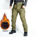 Men's tactical cargo pants in green, water-resistant soft shell with fleece lining, ideal for outdoor and tactical activities.