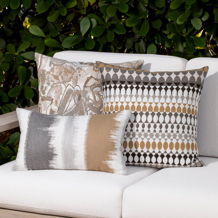 Outdoor image of pillows in Modern Oval Dune – outdoor-safe woven fabric by Elaine Smith, ideal for high-end commercial and residential applications.