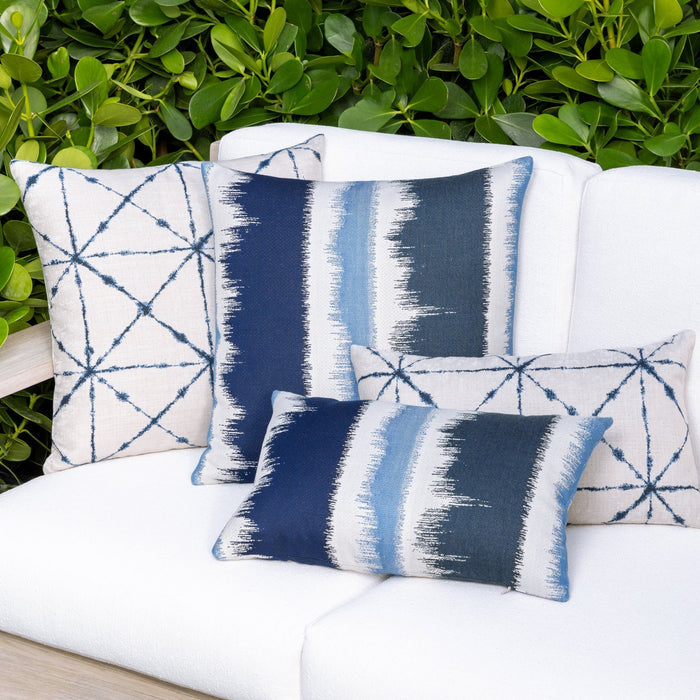 Outdoor image of group of pillows in indigo in variety of patterns, all are outdoor safe