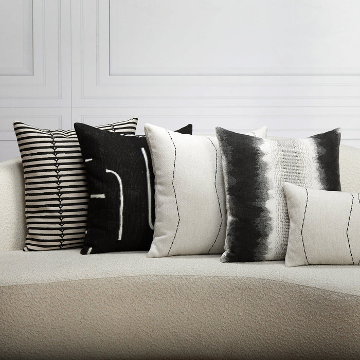 Indoor environmental image of pillows in Minimalist black linear geometric pattern woven into textured boucle outdoor safe fabric