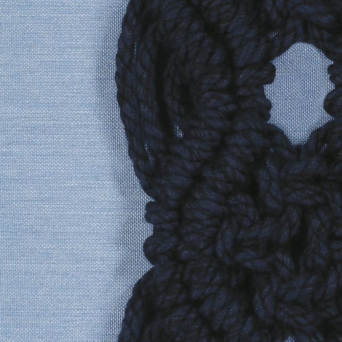 Detail image of Blue pillow with dark blue macrame detailing as center band, lumbar size for bold indoor and outdoor decor