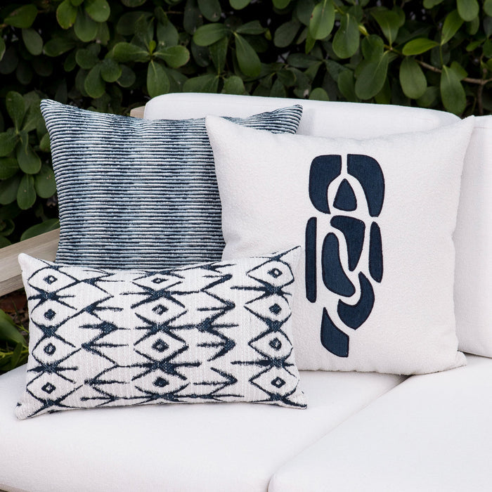 Outdoor image of pillows in Linear indigo outdoor-safe fabric with a soft gradient stripe pattern