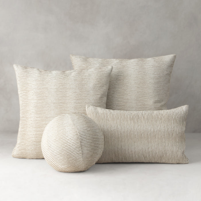 Set of textured pillows and a ball on a neutral background