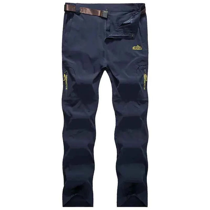 Black and grey men's quick-drying outdoor hiking pants by Mead's Supply & Equipment, waterproof, anti-UV, and breathable trekking gear.