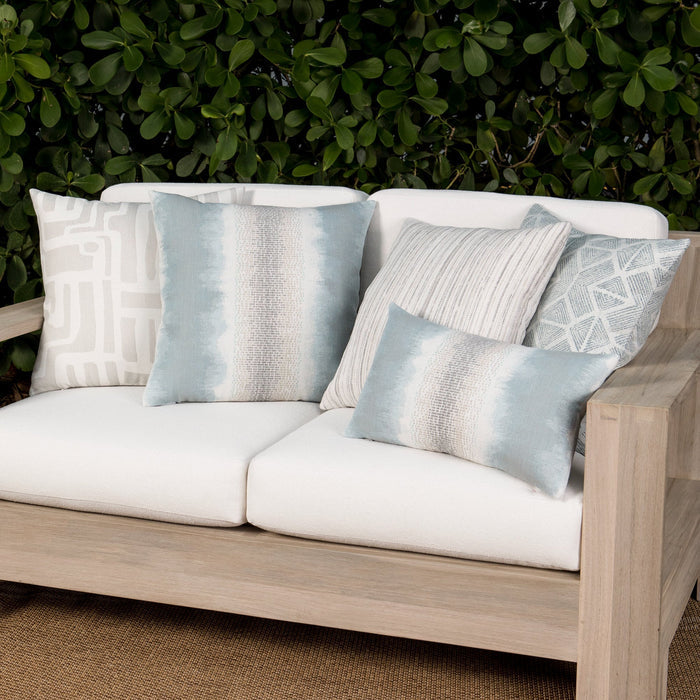 Luxury light blue striped and other soft blue decorative pillows on a outdoor sofa, featuring commercial grade construction for luxury hotel and resort design