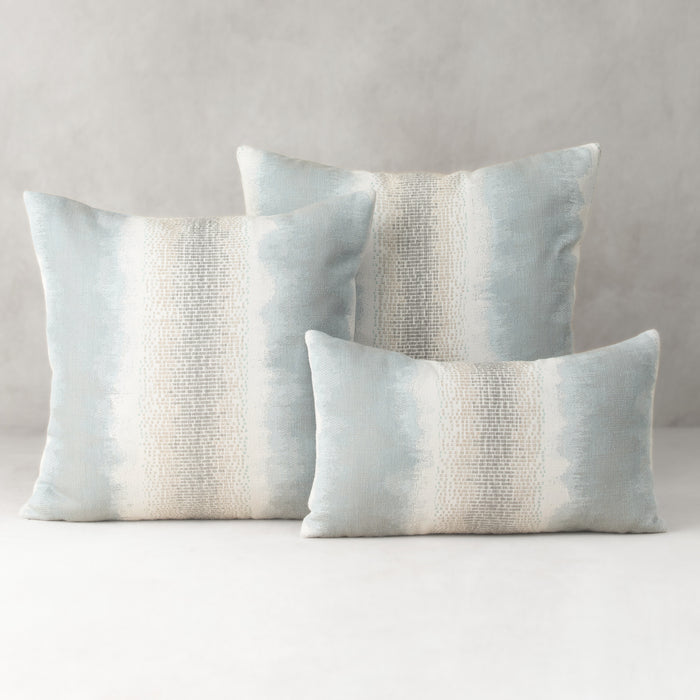 Three decorative pillows with a gradient pattern on a neutral background