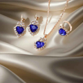Stylish 3Sixty5 jewelry set with royal blue rhinestone splash design, featuring a heart-shaped piece and matching accessories.