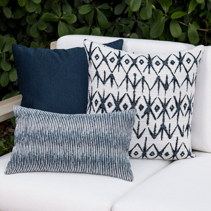 Outdoor image of pillows in Tribal-inspired indigo and white patterned outdoor safe woven fabric