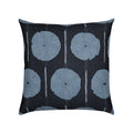 A square throw pillow featuring a dark charcoal background with a repeating pattern of muted blue-gray circular motifs and thin vertical white lines.