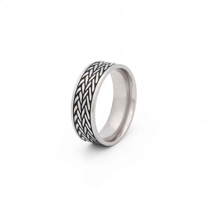 Stainless steel leaf pattern band ring by Glitters featuring detailed engraved leaf design on a smooth band.
