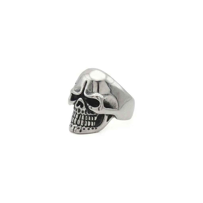 Stainless steel skull ring with tribal pattern from Glitters, showcasing detailed design and polished finish.