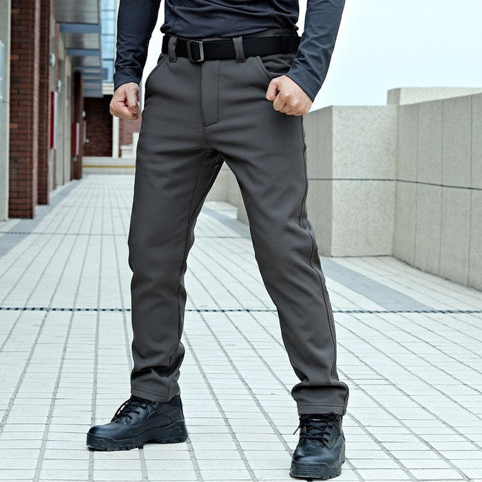 Water-resistant tactical soft shell cargo pants with fleece lining, windbreaker style, available in sizes 32-42.