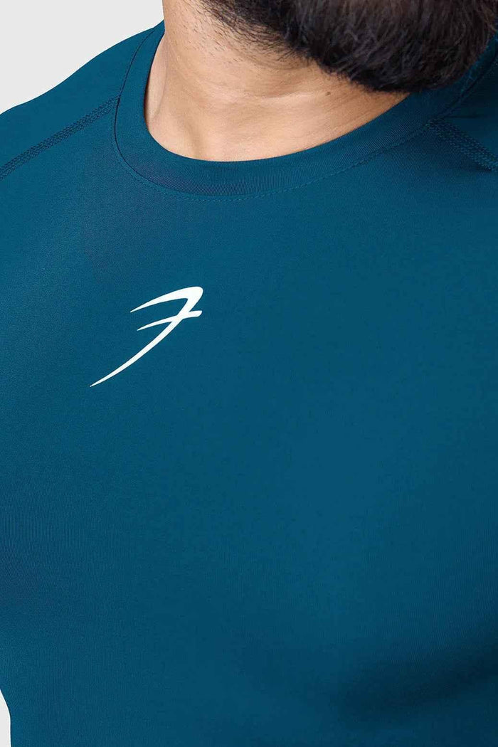 Men's teal compression T-shirt by Fuaark Nz, designed to enhance workout performance with a snug, supportive fit.