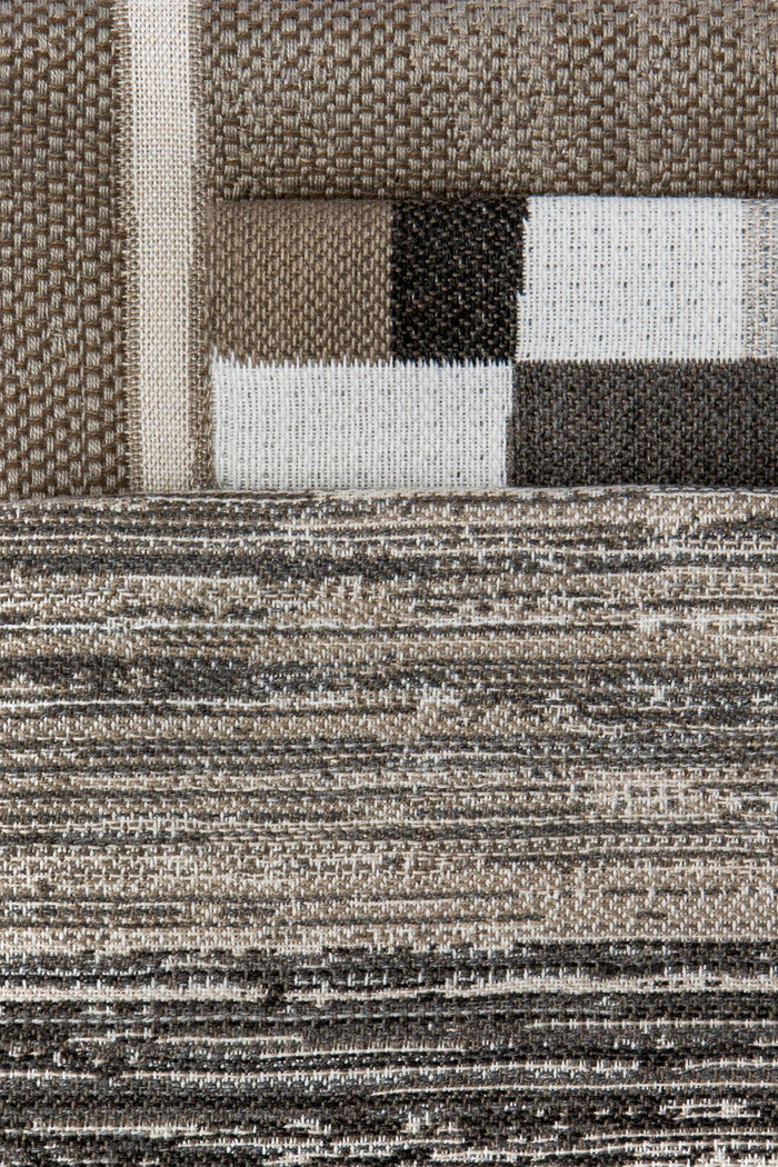 Coordinating fabrics to Close-up of a textured rug with geometric pattern
