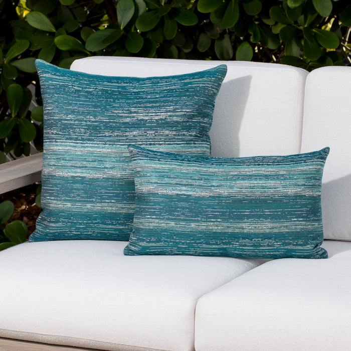 Outdoor image of teal ombre stripe pillows on outdoor sofa