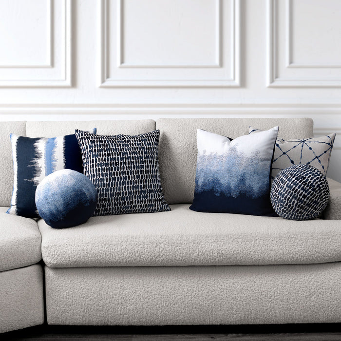 Gray sofa with decorative pillows featuring blue and white patterns in a room with white paneled walls. - outdoor safe by Elaine Smith