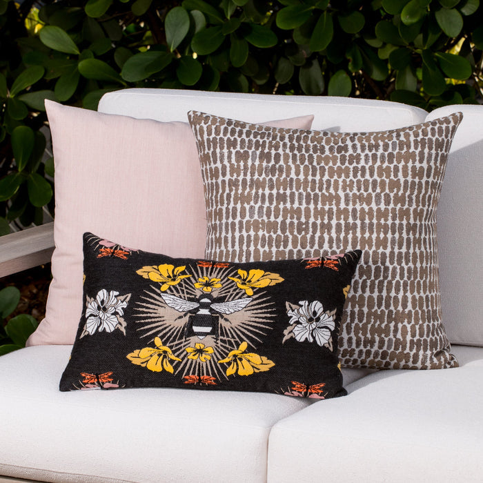 Outdoor image of pillows in Thumbprint Latte – outdoor-safe woven fabric by Elaine Smith, ideal for high-end commercial and residential applications.
