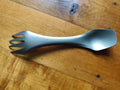 Titanium 3-in-1 camping utensil from Mead's Supply & Equipment, ultralight spork with knife edge for outdoor camping gear.