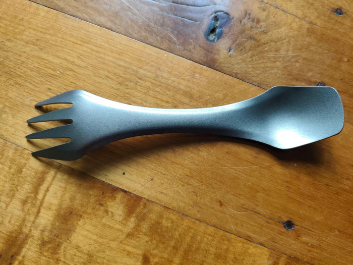 Titanium 3-in-1 camping utensil from Mead's Supply, ultralight spork with knife edge, ideal for camping equipment.
