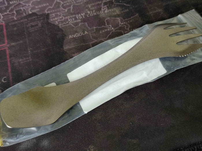Titanium 3-in-1 camping utensil from Mead's Supply with spork, knife edge, and compact ultralight design for outdoor camping.