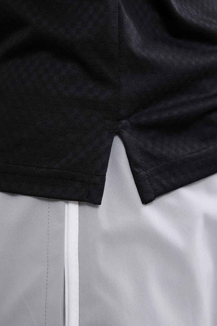 Black Wave Polo T-shirt by Fuaark NZ, showing a close-up of the stylish polo collar and fabric texture.